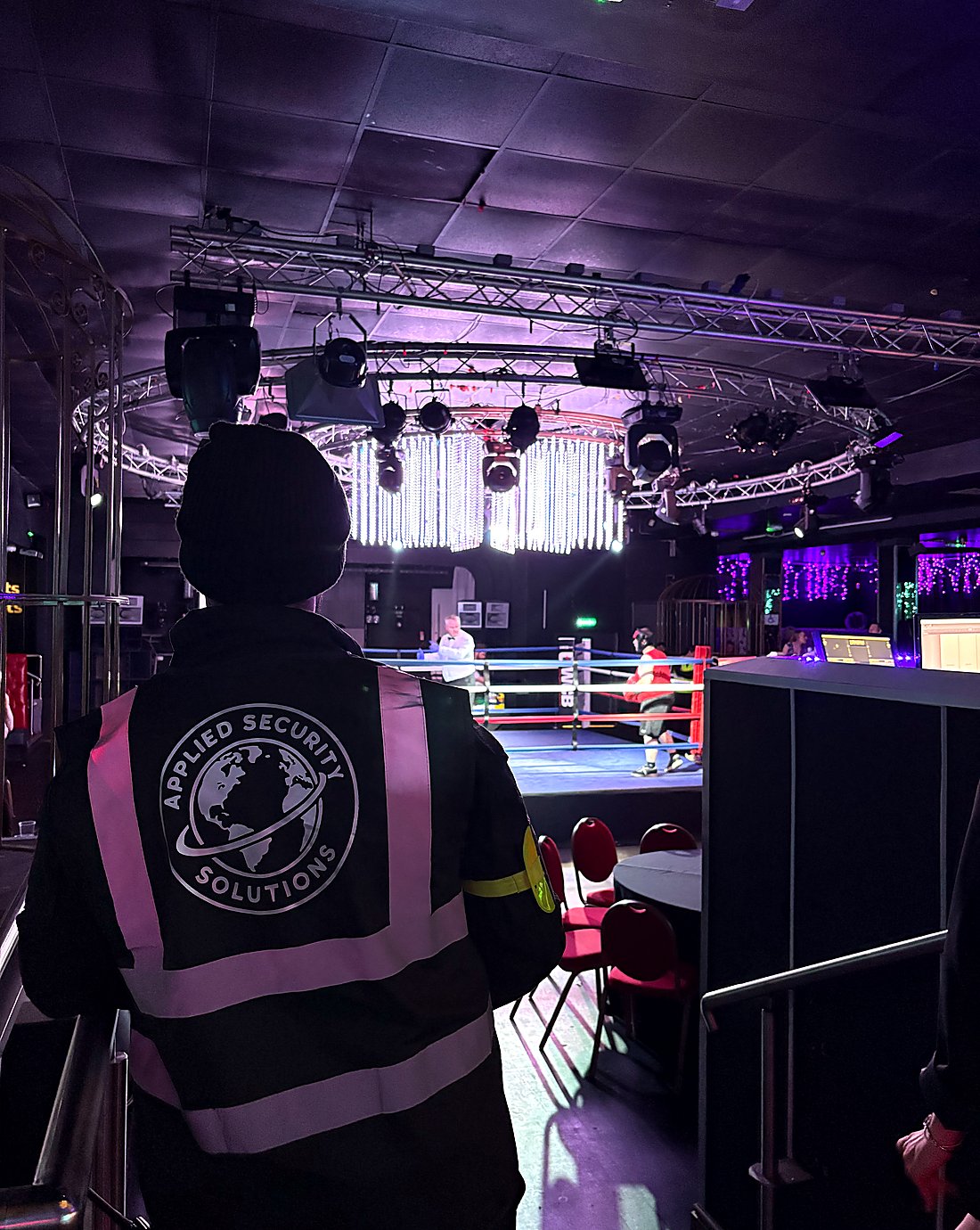 Applied Security Solutions officer positioned beside a boxing ring with clear visibility across the venue