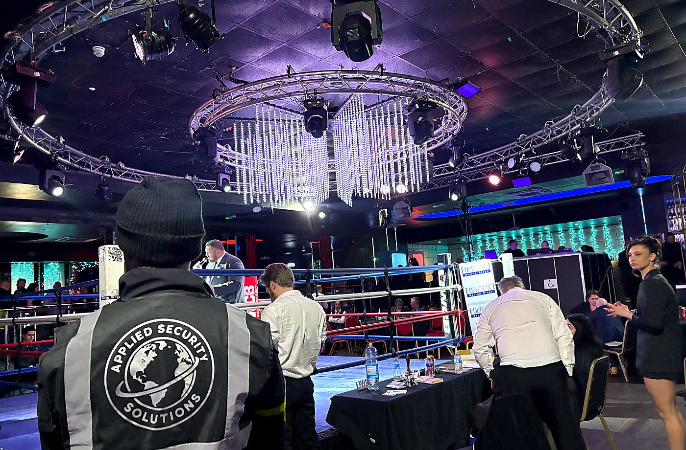 Applied Security Solutions officer supporting event operations beside a boxing ring